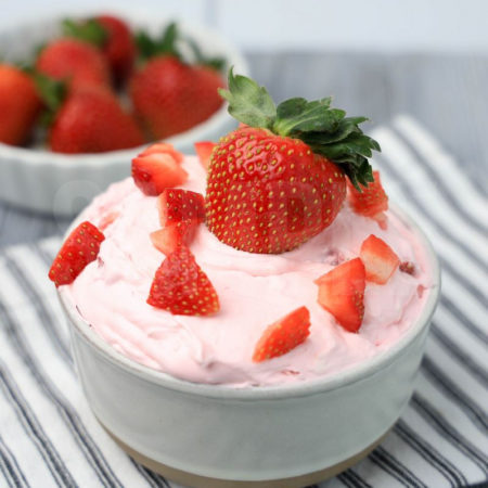 The Strawberry Valentine's Day Dip comes in a stone bowl with a white striped napkin on a gray wood backdrop.