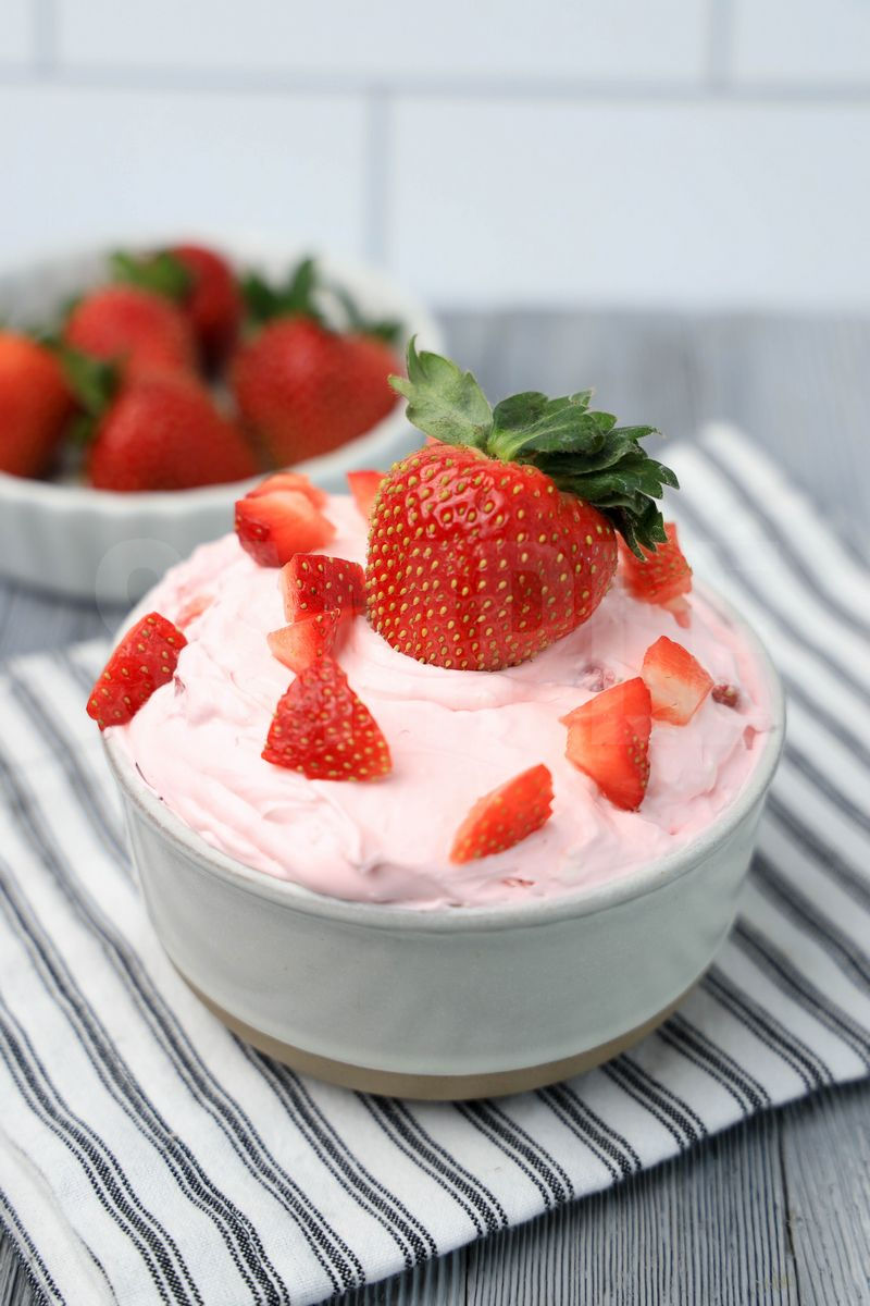 The Strawberry Valentine's Day Dip comes in a stone bowl with a white striped napkin on a gray wood backdrop.