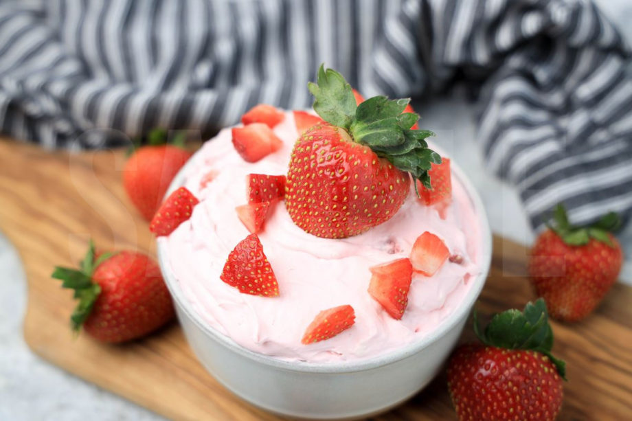 The Strawberry Valentine's Day Dip comes in a stone bowl with a gray striped napkin on a marble wood backdrop.