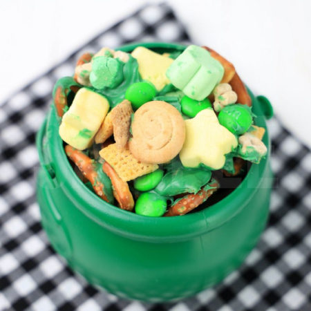 The Leprechaun Bait comes in a green cauldron with a plaid napkin on a white wood backdrop.