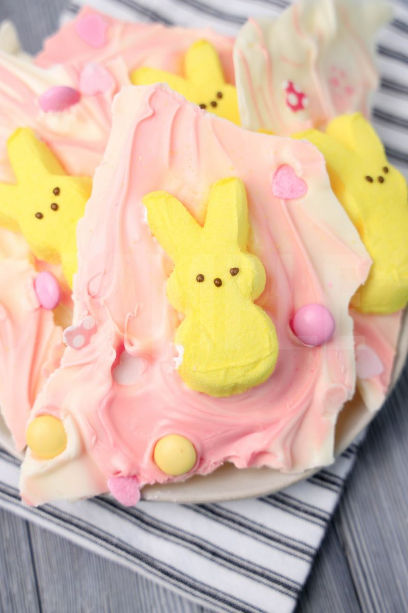 The Peeps Bunny Bark comes on a white plate with a white striped napkin on a gray wood backdrop.