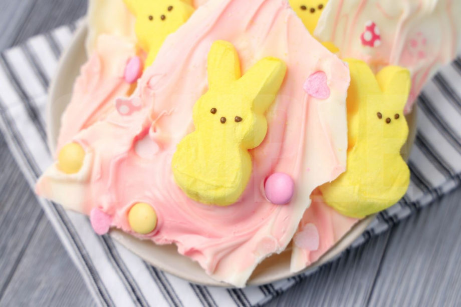 The Peeps Bunny Bark comes on a white plate with a white striped napkin on a gray wood backdrop.