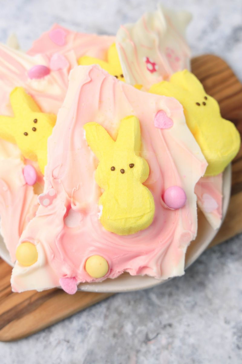The Peeps Bunny Bark comes on a white plate with a gray striped napkin on a marble backdrop.
