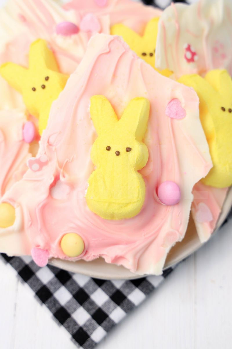 The Peeps Bunny Bark comes on a white plate with a plaid napkin on a white wood backdrop.