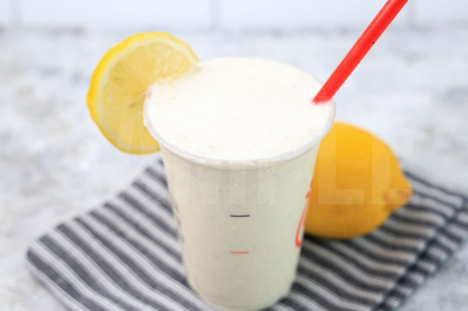 The Frosted Lemonade Chick Fil A Copycat comes in a cup with a gray striped napkin on a marble backdrop.