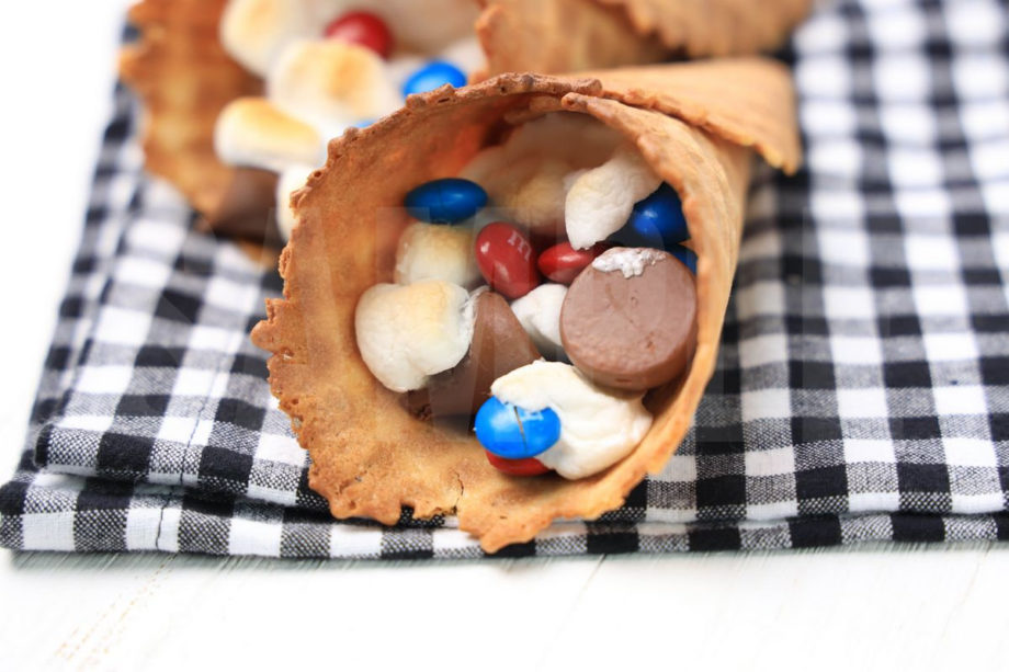The 4th Of July Campfire Cones comes on a plaid napkin on a white wood backdrop.