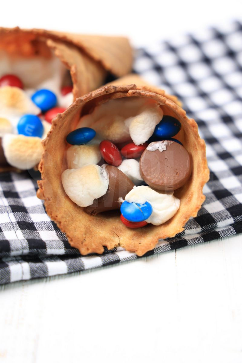 The 4th Of July Campfire Cones comes on a plaid napkin on a white wood backdrop.