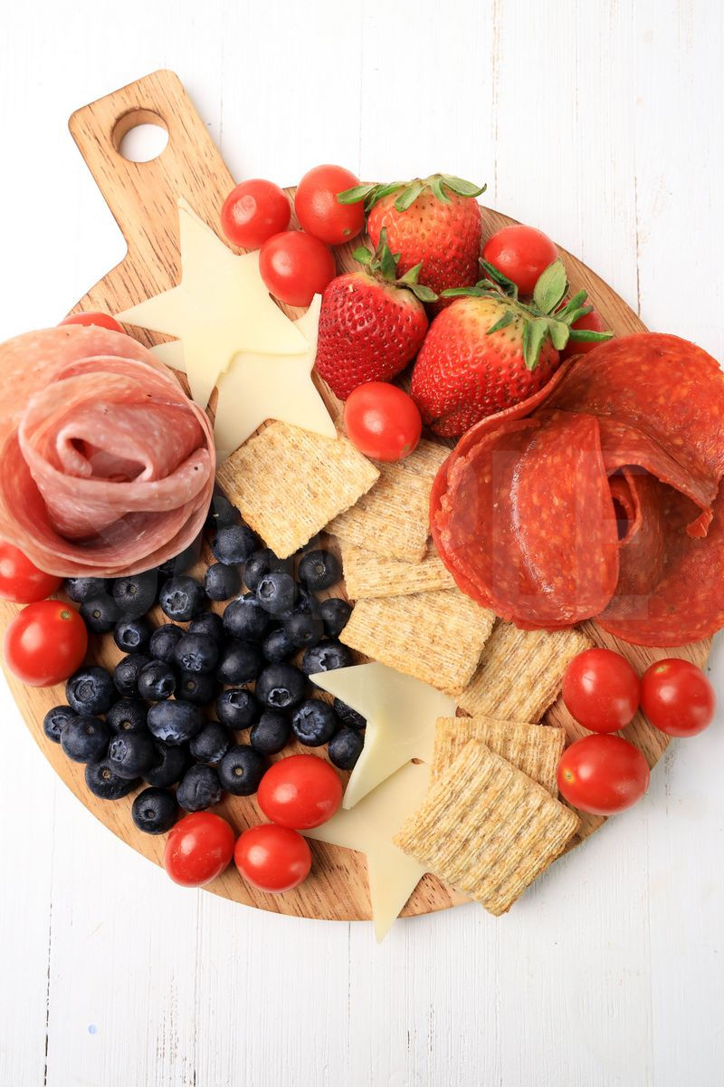 The 4th Of July Charcuterie Board comes on a white wood backdrop.