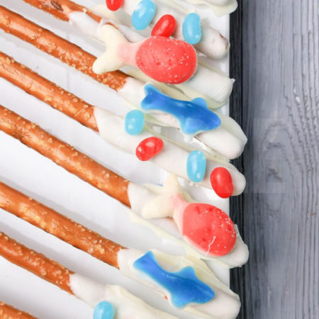 The Sealife Pretzel Rods comes on a white plate with a gray wood backdrop.