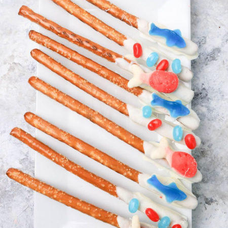 The Sealife Pretzel Rods comes on a white plate with a marble backdrop.