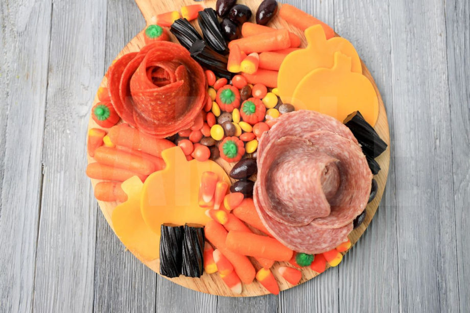 The Halloween Charcuterie Board comes on a gray wood backdrop.