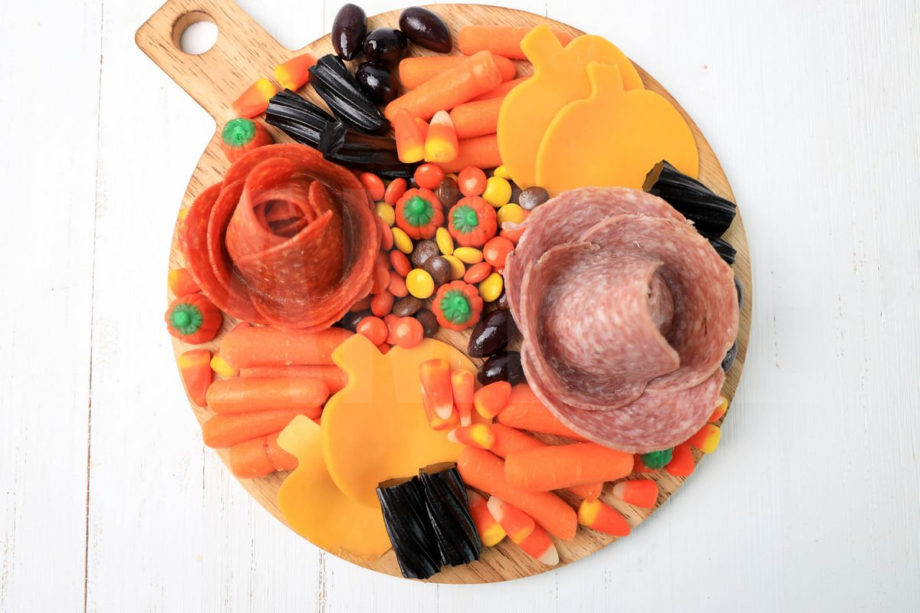 The Halloween Charcuterie Board comes on a white wood backdrop.