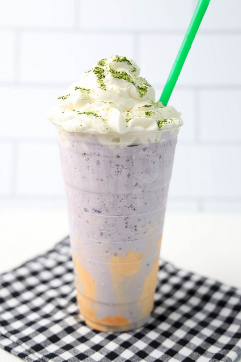 The Halloween Frappuccino Starbucks Copycat comes in a venti cup with a plaid napkin on a white wood backdrop.