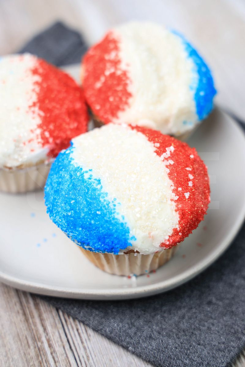 The Snow Cone Cupcakes comes on a denim napkin on a rustic wood backdrop.