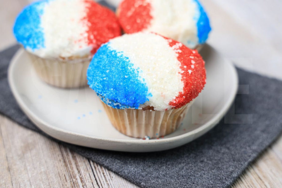 The Snow Cone Cupcakes comes on a denim napkin on a rustic wood backdrop.