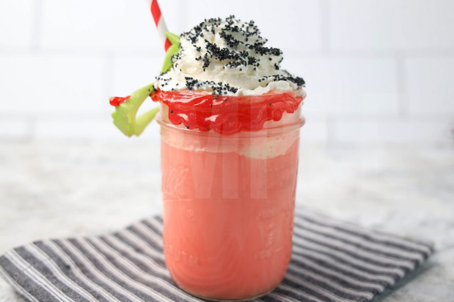 The Vampire Float comes in a mason jar with a gray striped napkin on a marble backdrop.