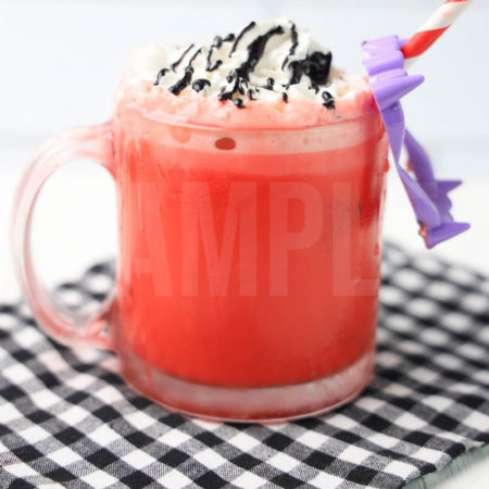 The Vampire Hot Chocolate comes in a glass coffee mug on a white wood backdrop.