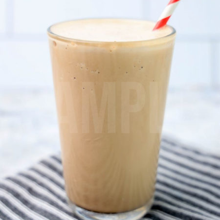 The Wendy's Chocolate Frosty Copycat comes in a glass on a gray striped napkin on a marble backdrop.