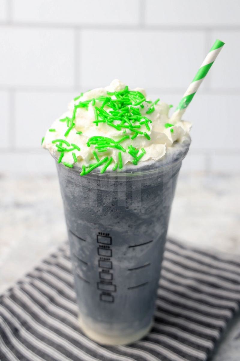 The Beetlejuice Frappuccino Starbucks Copycat comes in a venti cup with a gray striped napkin on a marble backdrop.