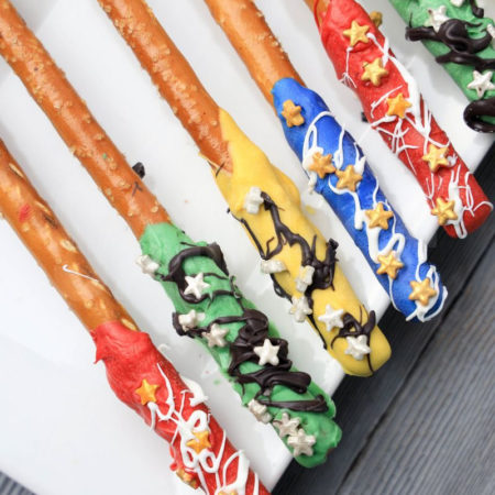 The Harry Potter House Pretzel Rods comes on a white plate on a gray wood backdrop.