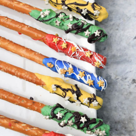 The Harry Potter House Pretzel Rods comes on a white plate on a marble backdrop.
