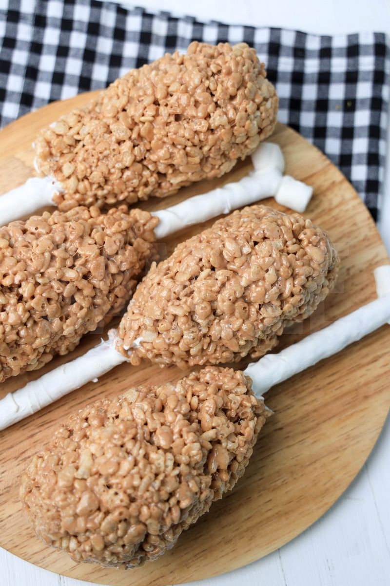 The Turkey Leg Rice Krispies Treats comes on a wood board on a white wood backdrop.