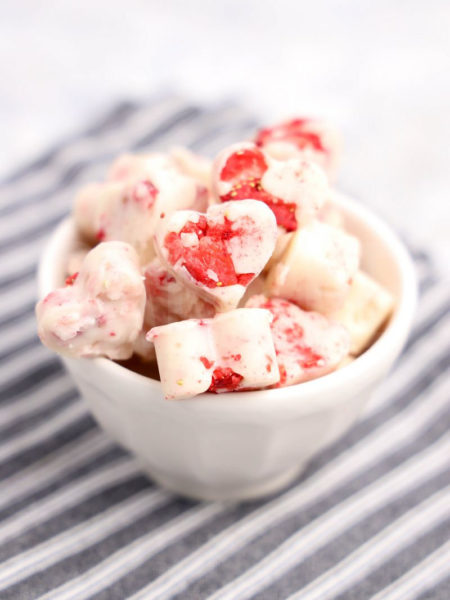 The Strawberry Fudge Hearts comes in a white bowl with a gray striped napkin on a marble wood backdrop.